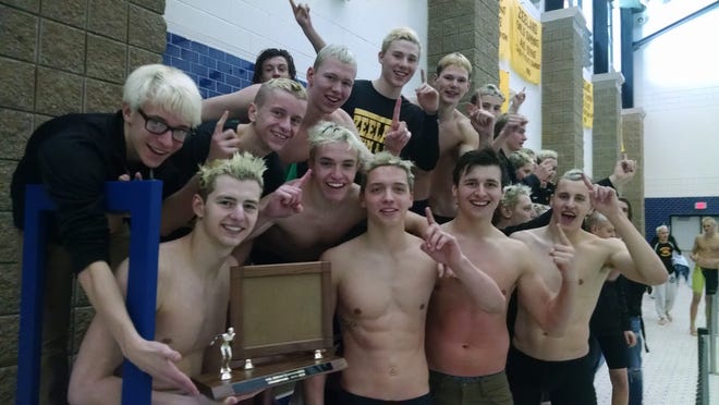 The Zeeland boys swimming & diving team celebrates after winning the OK Green Conference title on Saturday, Feb. 27. Contributed/Beau Troutman