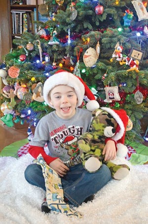 Asher Doremus, 5, pictured at Christmas with his favorite teddy bear, was diagnosed last fall with sensory processing disorder. Asher’s family has begun raising funds to provide a service dog to help Asher cope with the condition.