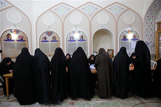 Iranian women vote in the parliamentary and Experts Assembly elections at a polling station in Qom, 125 kilometers (78 miles) south of the capital Tehran, Iran, Friday, Feb. 26, 2016. Iranians across the Islamic Republic voted Friday in the country's first election since its landmark nuclear deal with world powers, deciding whether to further empower its moderate president or side with hard-liners long suspicious of the West. The election for Iran's parliament and a clerical body known as the Assembly of Experts hinges on both the policies of President Hassan Rouhani, as well as Iranians worries about the country's economy, long battered by international sanctions. (AP Photo/Ebrahim Noroozi)