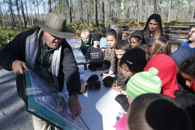 Parks and Recreation Superviser Dale Colby educates Oakland Terrace second-graders in the outdoor classroom at the Conservation Park in Panama City Beach. The nonprofit Ducks Unlimited organization is involved in a conservation programs throughout North America.