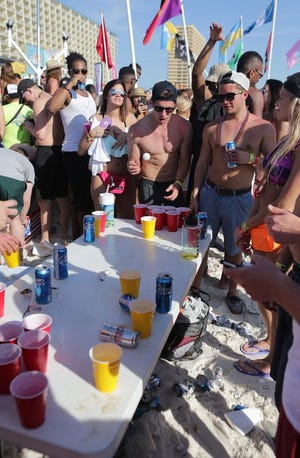 College students play beer pong during the second week of Spring Break in March last year in Panama City Beach.
