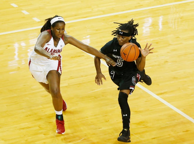 South Carolina guard Khadijah Sessions, right, drives the ball to the basket against Alabama guard Breanna Hayden, left, during the second half of an NCAA college basketball game, Monday, Feb. 22, 2016, in Tuscaloosa, Ala. (AP Photo/Brynn Anderson)