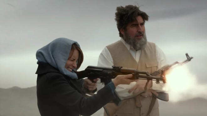 Tina Fey fires off a few rounds under the supervision of Alfred Molina.

Courtesy Photo