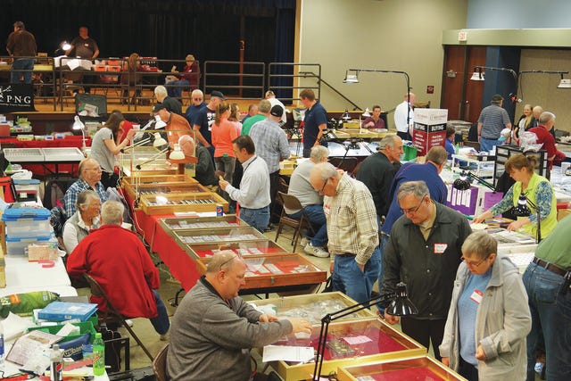 People look around the Coin-A-Rama coin show this past weekend. The event is sponsored by the Ames Coin Club. Photo by Trinity Baker for the Nevada Jounrnal 
 Dan and Brenda Doss of Quad City Coins show their selection to the Ames Coin Club’s president Dillon Kraft. 
 Vendor Harley Fenton had a number of things on hand for visitors to see. 
 The show offered food options during the two days. 
 Kevin Lunn of North Star Stamps & Collectibles out of Jewell had a few tables covered with stamps from all over the world. While coins are the main thrust of the show, there were also other collectibles, like stamps and postcards.