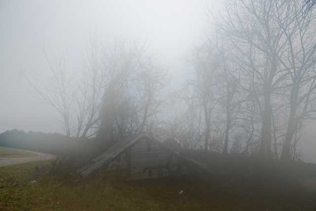 Gray skies settle over the remains of a collapsed barn lying in a field off Institute Road. Rain, wind and cold weather drifted throughout Lenoir County as winter storms swept across the state last week. Editor’s note: Additional fog was created by a humidity change on the lens by the photographer.