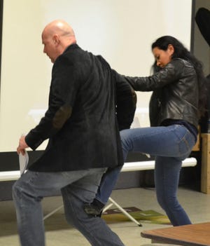 Photo by Joe Carlson/New Jersey Herald - Mike Barnard and an unidentified woman demonstrate a maneuver during the “How to Survive a Mass Shooting” event.