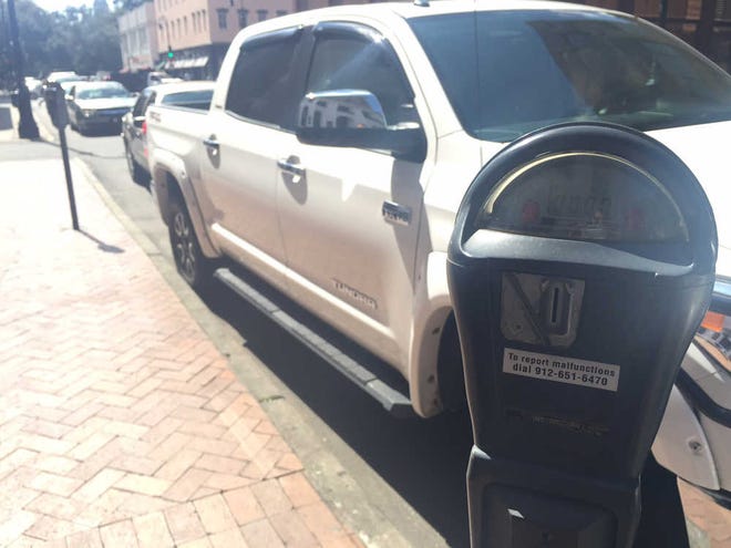 Vehicles line the metered parking spots on Bull Street. A consultant hired by the city to conduct a parking study is recommending paid parking hours be extended into evenings and Saturdays. (Eric Curl/Savannah Morning News)