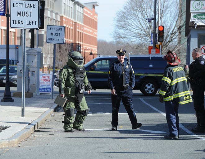 A State Police Bomb Squad member exits the Brockton Downtown Health Center on Tuesday, March 1, 2016, after searching the building. He did not find a bomb.