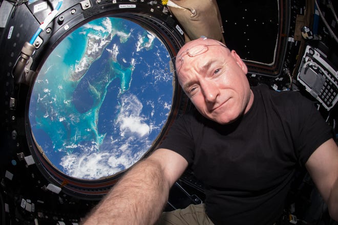In this July 12, 2015 photo, Astronaut Scott Kelly takes a photo of himself inside the Cupola, a special module of the International Space Station which provides a 360-degree viewing of the Earth and the station. (Scott Kelly/NASA via AP)