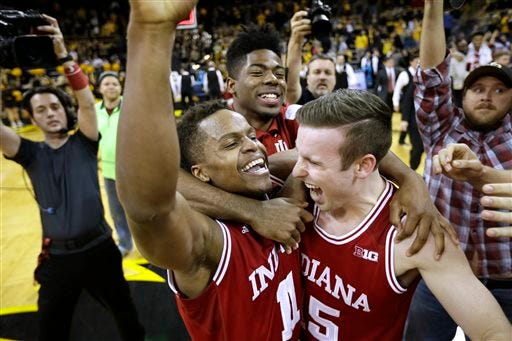 Indiana guard Yogi Ferrell celebrates with teammate Harrison Niego, right, after an NCAA college basketball game against Iowa, Tuesday, March 1, 2016, in Iowa City, Iowa. Ferrell scored 20 points as Indiana won 81-78 and clinched the Big Ten title.