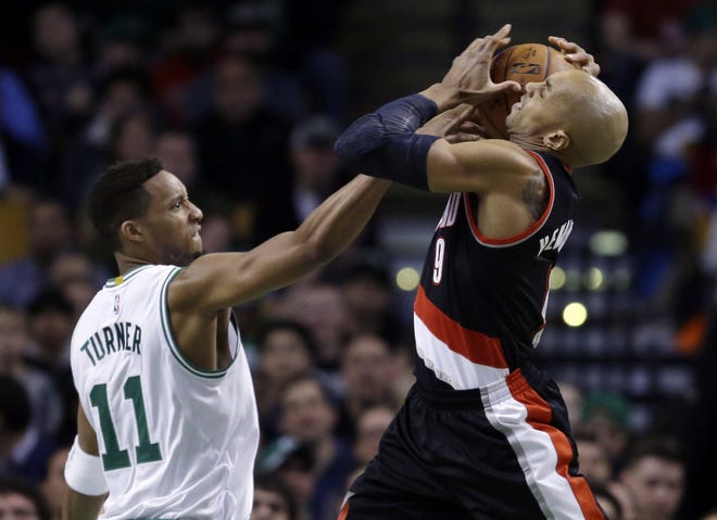 Celtics guard Evan Turner (left) blocks the drive of Trail Blazers guard Gerald Henderson during the first quarter of Boston's 116-93 win on Wednesday night.