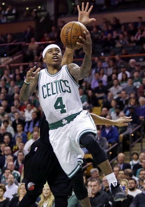Isaiah Thomas of the Celtics drives by Portland's C.J. McCollum on Wednesday night.