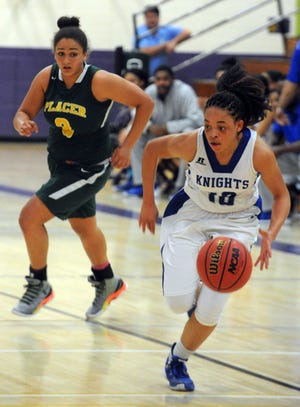 Brookside Christian guard Shaylene Stark, right, drives past Placer's Raven Lewis during their Sac-Joaquin Section Division IV girls basketball semifinal Tuesday at Tokay's John Giannoni Gym in Lodi. Brookside Christian won 66-35 to advance to the Division IV finals against West Campus. CALIXTRO ROMIAS/THE RECORD