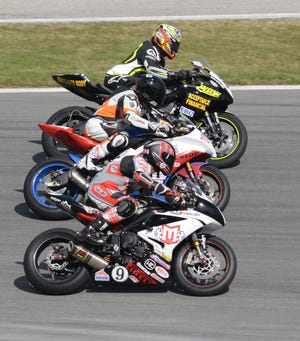 Riders go three-wide during the 2015 Daytona 200 motorcycle classic at Daytona International Speedway. NEWS-JOURNAL/PETER BAUER