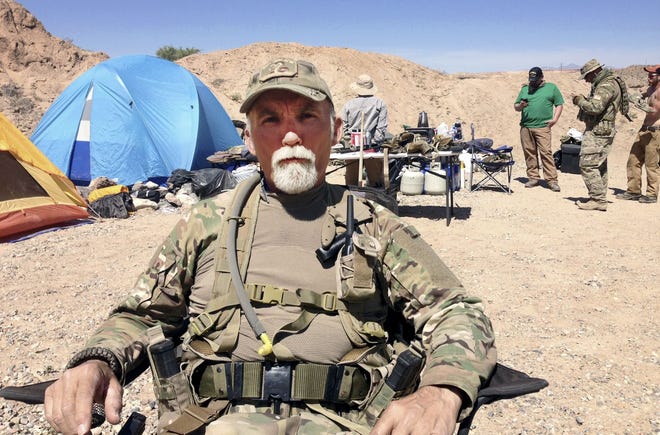In this April 16, 2014 file photo, Jerry DeLemus, of Rochester, sits with a group of self-described militia members camping on rancher Cliven Bundyís ranch near Bunkerville, Nev. Federal agents arrested DeLemus Thursday in New Hampshire. He faces multiple federal charges in Nevada. AP file photo/Ken Ritter
