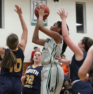 Ashbrook's Evonna McGill drives to the basket between South Iredell's Taylor Berg and Alexis Walker during their first round 3A playoff game Tuesday night at Ashbrook High School. JOHN CLARK/THE GAZETTE