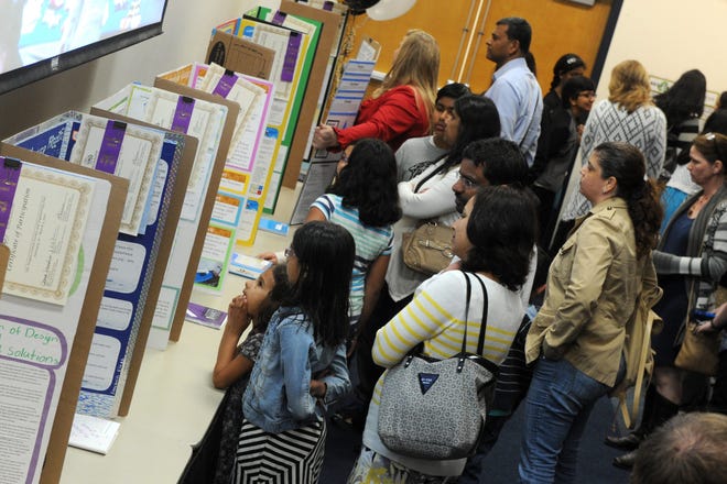A large crowd check the winning science exhibits at the San Joaquin Office of Education Science and Engineering Fair at the Wentworth Education Center. CALIXTRO ROMIAS/THE RECORD