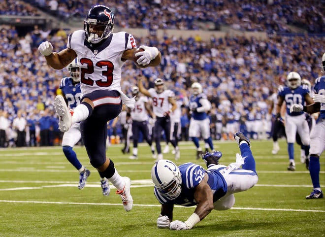 Houston Texans running back Arian Foster gets past Indianapolis Colts linebacker Jeff Tarpinian during the second half of a game on Dec. 14, 2014, in Indianapolis. The four-time Pro Bowler was released by the Texans on Thursday. (AP Photo/AJ Mast)