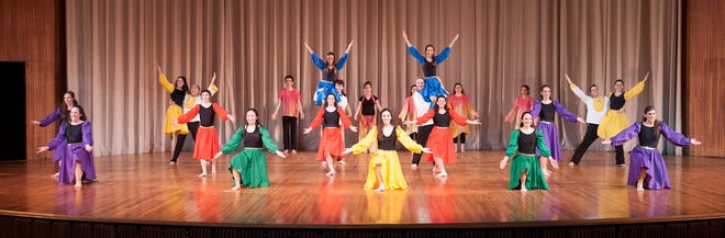 Brighton residents Eliana Wachs Cashman, first row, first on right; Rina Wagman, second row, first on right; and Paul Rosenstrauch, center left, rear, lifting a dancer, performing with the Shiluv dance group at the 2015 Israel Folkdance Festival of Boston. Courtesy Photo / Emily Sper