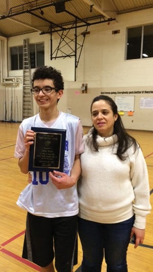 Adrian DeLeon, who received the "T" Miller Sportsmanship Award, is accompanied by his mother Andrea DeLeon.