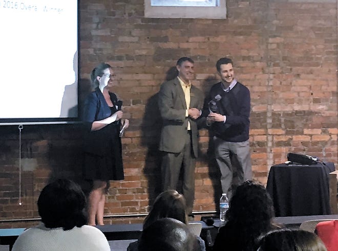 Trey Gordner, right, of Koios accepts his award as overall winner of the Creative Coast's annual FastPitch competition on Friday. (Katie Martin/Savannah Morning News)