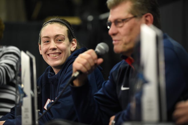 UConn's Breanna Stewart smiles as her coach Geno Auriemma talks about the American Athletic Conference tournament Friday during a news conference at Mohegan Sun Arena. Stewart was named AAC player of the year and Auriemma was named AAC coach of the year. Cloe Poisson/Hartford Courant via the associated press