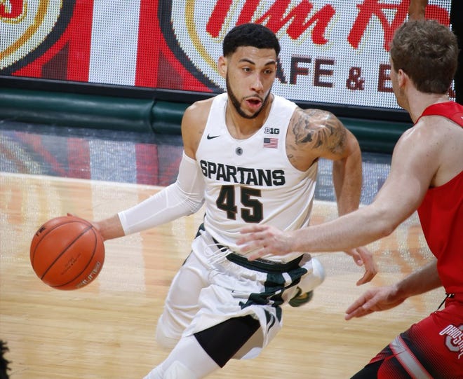 Michigan State's Denzel Valentine drives against Mickey Mitchell of Ohio State. The Buckeyes did little to slow the Spartans senior, who had 27 points and a career-high 13 assists.
