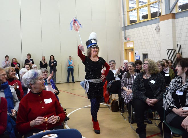 Pat Spalding, majorette of the Leftist Marching Band, marches into the gynmasium at Community Campus in Portsmouth Saturday to give the keynote address with Susan Poulin, also known as "Ida LeClair, the funniest woman in Maine," at the 10th annual Seacost Women's Week Conference. Proceeds from the conference will benefit Womenaid of Greater Portsmouth. Suzanne Laurent photo