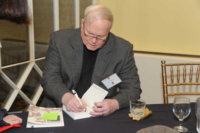 Graham Martin/Correspondent Author Pat Conroy signing one of his books during a reception Thursday night at Flagler College.