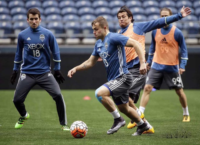 Seattle Sounders forward Jordan Morris dribbles in front of Nelson Valdez as Nathan Sturgis, left, looks on during a training session on Feb. 22 in Seattle. (AP Photo/Elaine Thompson)