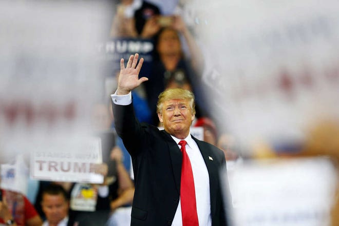 Republican presidential candidate Donald Trump waves to the crowd before he speaks during a campaign rally Saturday, March 5, 2016, in Orlando, Fla. (AP Photo/Brynn Anderson)