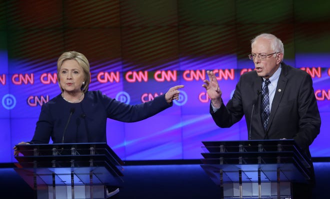 Democratic presidential candidates Hillary Clinton, left, and, Sen. Bernie Sanders, I-Vt., argue a point during a Democratic presidential primary debate at the University of Michigan-Flint, Sunday, March 6, 2016, in Flint, Mich. (AP Photo/Carlos Osorio)