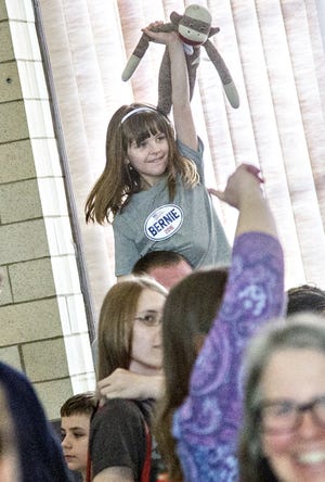 Amelia Chasse, 8 1/2, raises her hand to speak for her suppoort of Bernie Sanders at Berwick Town Hall Sunday for their Democratic caucus. Photo by John Huff/Fosters.com
