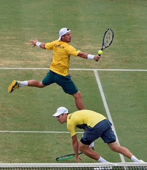 Australia's Lleyton Hewitt, top, and John Peers play against Bob and Mike Bryan of the United States during their Davis Cup doubles match in Melbourne, Australia, Saturday, March 5, 2016. (AP Photo/Andrew Brownbill)