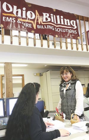 Ohio Billing founder and CEO Terri Davis talks with a employee in the office in Bolivar.