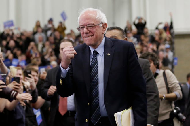 Democratic presidential candidate, Sen. Bernie Sanders, I-Vt, pumps his fist as he arrives for at a rally at the Macomb Community College, Saturday, March 5, 2016, in Warren, Mich. (AP Photo/Carlos Osorio)
