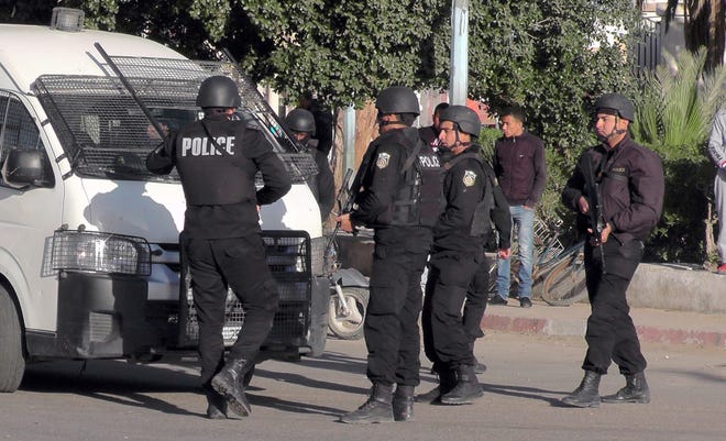 Tunisian police officers take positions during fightings with Islamic State group militants in Ben Guerdane, 650 km away from Tunis, on Monday. Tunisia's prime minister says an attack by extremist gunmen on a Tunisian town near the Libyan border was an effort by the Islamic State group to establish a stronghold in the region. THE ASSOCIATED PRESS