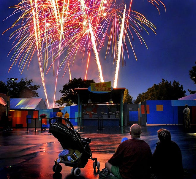 (File) Will and Kathy McCann, of Richmond, Virginia, watch the Independence Day firework show at Sesame Place in 2007.  Washington Crossing Historic Park  is hoping to have a fireworks display this year along with a concert.