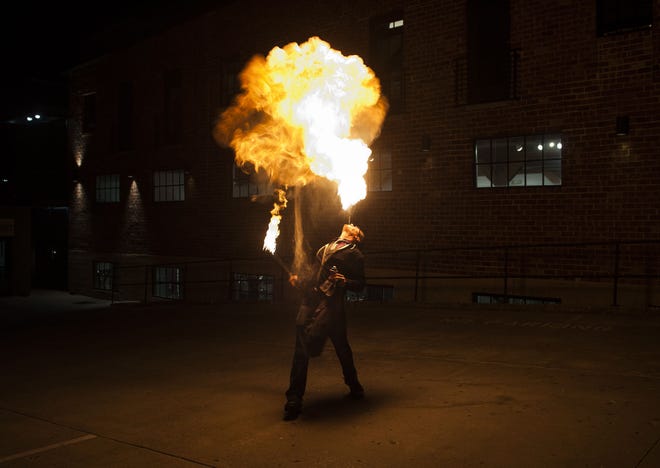 Cail Evans, member of Burn Circus, breathes fire during the True/False Film Fest on Friday outside ARTlandish Gallery.