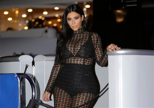 FILE - In this June 24, 2015 file photo, TV personality Kim Kardashian West poses during a photocall at the Cannes Lions 2015, International Advertising Festival in Cannes, southern France. Kardashian engaged in a Twitter battle with 19-year-old, actress Chloe Grace Moretz who criticized Kardashian's nude selfie. (AP Photo/Lionel Cironneau, File)