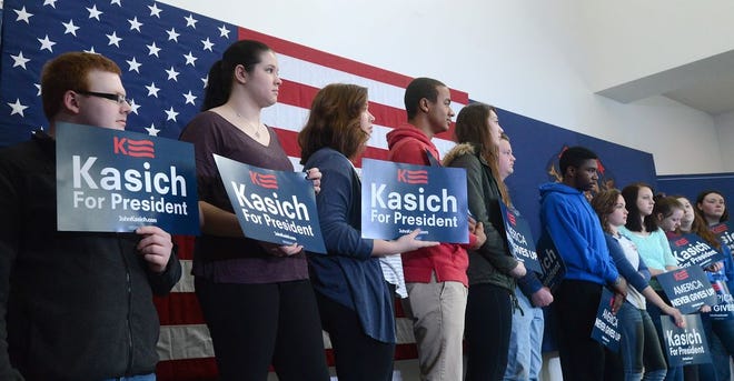 Monroe News photo by TOM HAWLEY
Monroe County Community College students behind holding signs in support as Republican presidential candidate Ohio Governor John Kasich spoke to a very large crowd in the La-Z-Boy Center atrium at Monroe County Community College Monday.