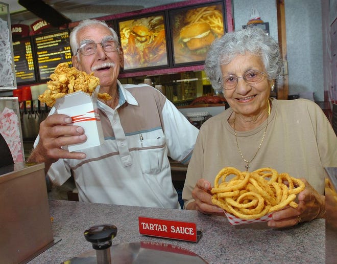 Tony and Tillie Kandalaft hold orders of their ever-popular fried clams and onion rings, behind the counter of Tony's Clam Shop, when Tony was 88 and Tillie was 87.