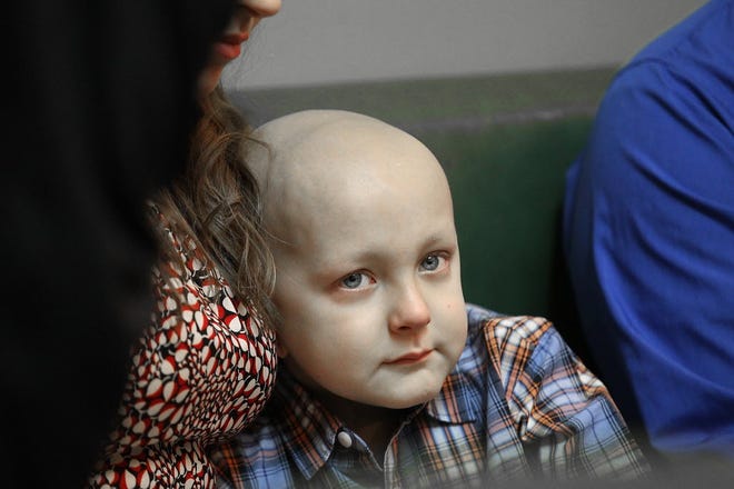 Dorian Murray sits with his mother, Melissa, in January when he was honored at the Rhode Island State House.
