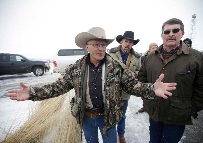 FILE - In this Jan. 9, 2016 file photo, Robert "LaVoy" Finicum, left, a rancher from Arizona, talks to reporters at the Malheur National Wildlife Refuge near Burns, Ore. On Tuesday, March 8, 2016, authorities said police were justified in killing Finicum during a traffic stop on Jan. 26, 2016. (AP Photo/Rick Bowmer, file)
