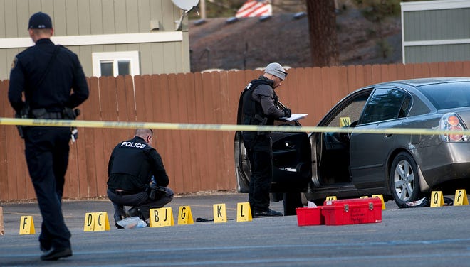 Coeur d’Alene police investigate the scene where Coeur d’Alene pastor Tim Remington was shot six times as he was leaving the Altar Church in Coeur d'Alene, Idaho after services on Sunday, March 6, 2016, but was expected to survive. (Kathy Plonka/The Spokesman-Review, via AP)
