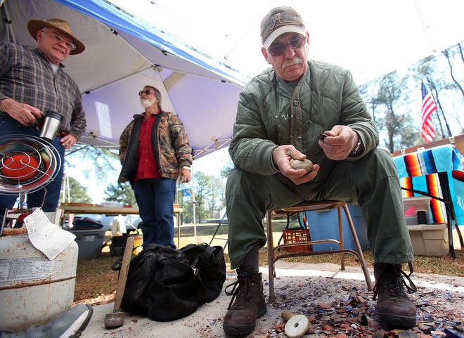 Moundville, Ala. -- Flint knapper Rick Findley, right, shapes a piece of stone into an arrow head at the Moundville Archeological Park Friday, Mar. 8, 2013. The 13th Moundville Knap In was held Friday and today (Saturday) from 9am to 5pm with only admission to the park being collected. The Knap In features craftsmen demonstrating Native American techniques for chipping stone into tools as well as ancient arts and crafts making, hunting techniques and music. There is also an area where children can have their faces painted, grind corn, make crafts and play Native American games. (Dusty Compton / Tuscaloosa News)