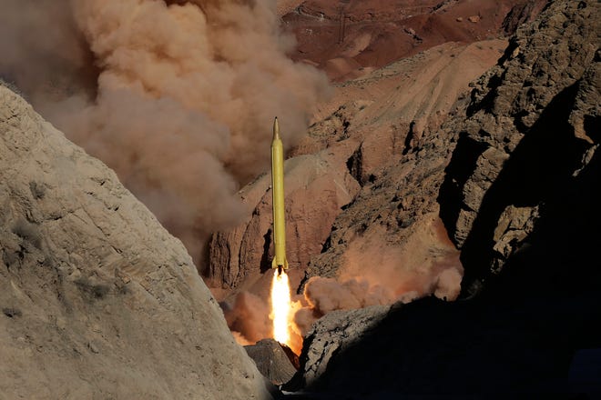 In this photo obtained from the Iranian Fars News Agency, a Qadr H long-range ballistic surface-to-surface missile is fired by Iran's Revolutionary Guard, during a maneuver, in an undisclosed location in Iran, Wednesday, March 9, 2016. Iran's powerful Revolutionary Guard test-fired two ballistic missiles Wednesday with the phrase "Israel must be wiped out" written on them, a show of deterrence power by the Islamic Republic as U.S. Vice President Joe Biden visited Israel, the semi-official Fars news agency reported. (AP Photo/Fars News Agency, Omid Vahabzadeh)