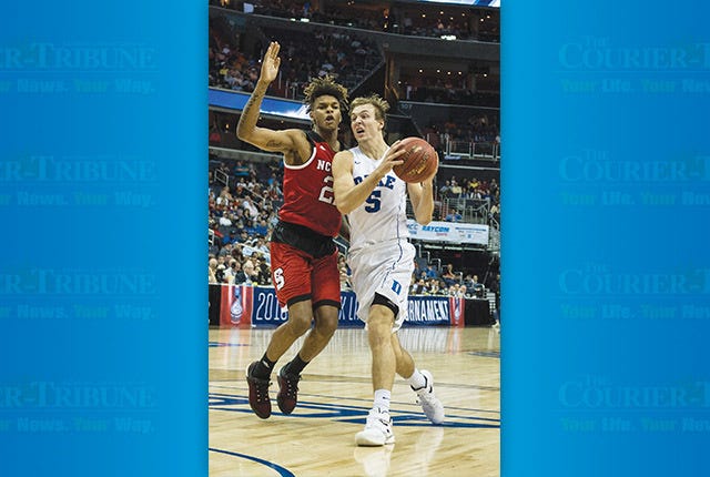 Duke Blue Devils guard Luke Kennard (5) drives the lane to the basket as North Carolina State Wolfpack guard Shaun Kirk (22) defends during the second round of the 2016 ACC Men's Basketball Conference tournament at the Verizon Center in Washington D.C. on March 9, 2016. PJ Ward-Brown/The Courier-Tribune