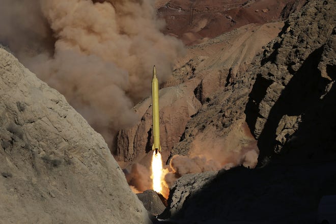 In this photo obtained from the Iranian Fars News Agency, a Qadr H long-range ballistic surface-to-surface missile is fired by Iran's Revolutionary Guard, during a maneuver, in an undisclosed location in Iran, Wednesday, March 9, 2016. Iranís powerful Revolutionary Guard test-fired two ballistic missiles Wednesday with the phrase "Israel must be wiped out" written on them, a show of deterrence power by the Islamic Republic as U.S. Vice President Joe Biden visited Israel, the semi-official Fars news agency reported. (AP Photo/Fars News Agency, Omid Vahabzadeh)