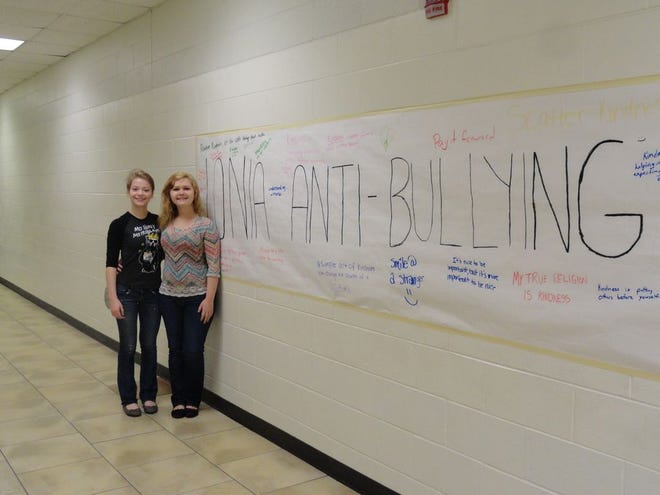 Ionia High School Sophomores, Aleah Edwards (left) and Mariah Miller (right) stand next to the wall of kindness.